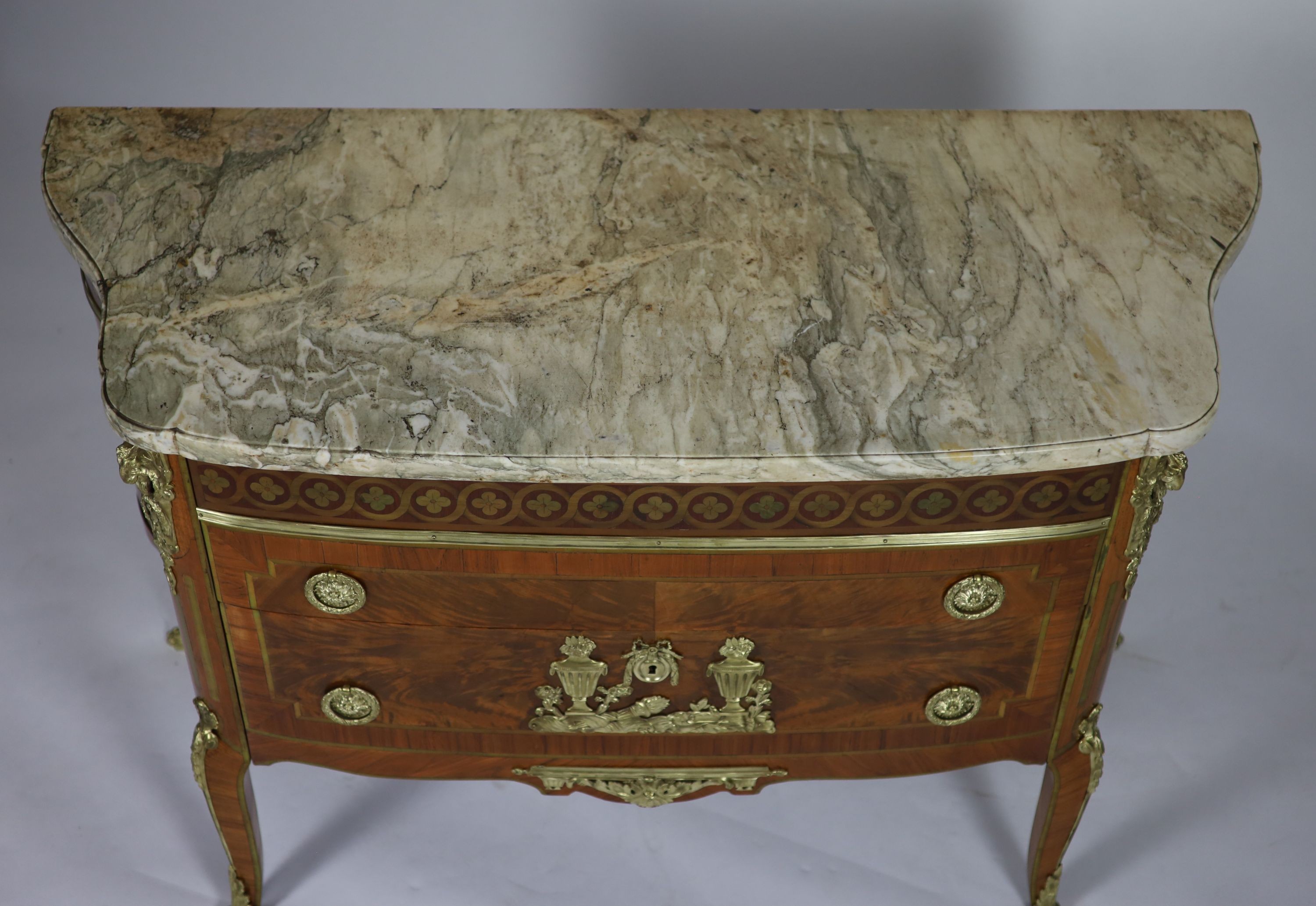 A late 19th century French marquetry and flame mahogany bowfront commode W.131cm D.54cm H.90cm